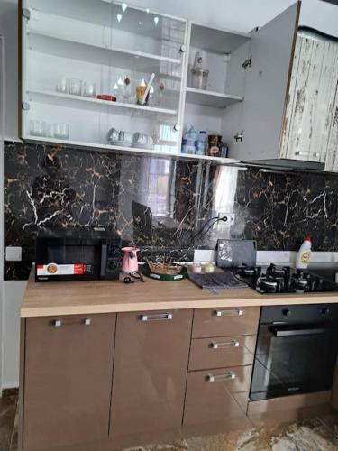 a kitchen with a stove and a counter top at Mihail apartments in Năvodari