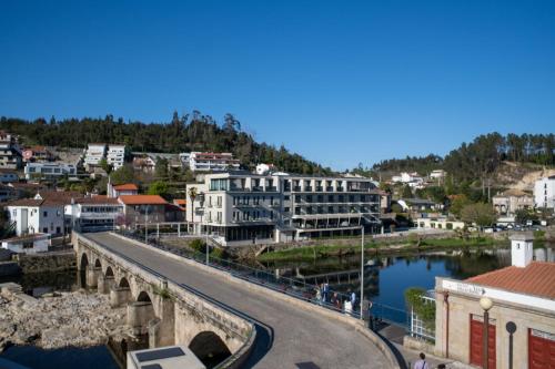 a city with a bridge over a body of water at Loureiro B&B in São Pedro do Sul
