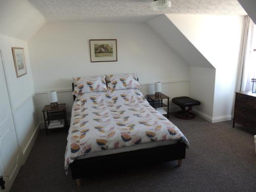 a bedroom with a bed with a comforter and pillows at 5A Union Road in Macduff