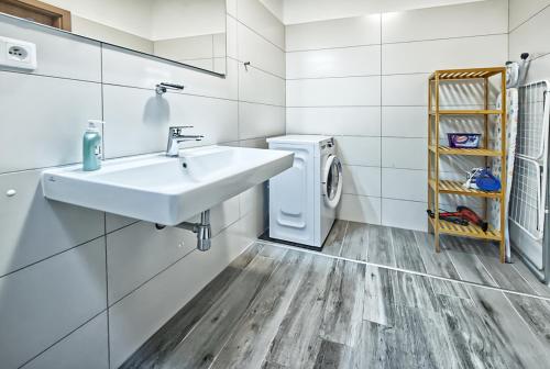 a bathroom with a sink and a washing machine at Nice accommodation in Mikulov in Mikulov