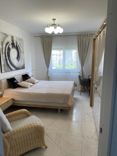 a bedroom with two beds and a chair in it at Luce del Sole in Montepaone Lido