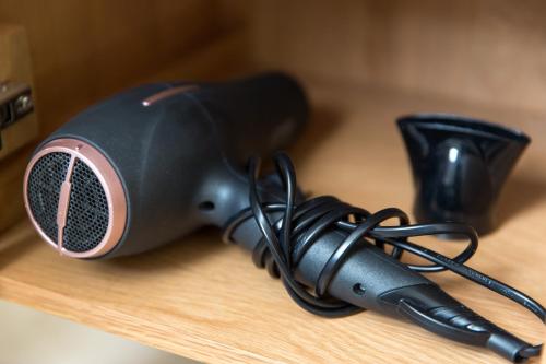 a hair dryer sitting on top of a table at Auguste, La Romaine et My César - Location Saverne in Saverne