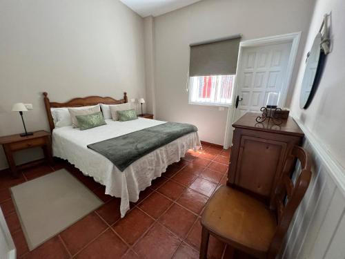 a bedroom with a bed and a table and a window at Finca La Romera in La Orotava