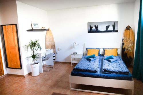 a bedroom with a bed with blue pillows at SURF DREAM House in Corralejo