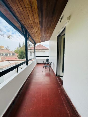 a balcony of a house with a bench on it at MAKTVB Europa - Hostal Boutique in Santiago