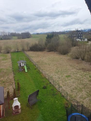 an aerial view of a garden with a bench and a fence at LONDYNEK in Poronin