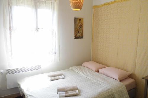 a bedroom with a bed with two towels on it at Fyllenia Country Home, Aridaia, Pozar Baths in Chrýsa