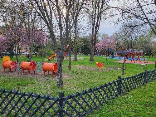 a park with a playground with play equipment in it at Jókai Apartman Szarvas in Szarvas