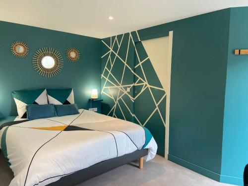 a bedroom with a large bed with blue walls at Au fil de l’Ô in Bisseuil