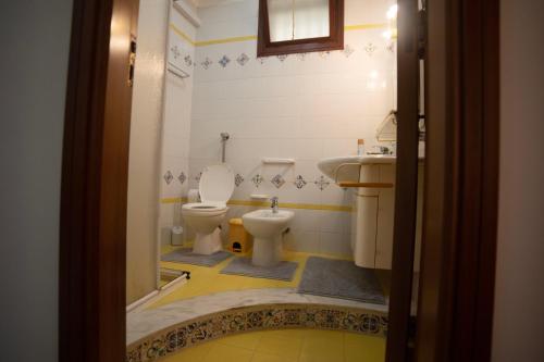 a bathroom with a toilet and a sink at Kasbah Apartment in Mazara del Vallo