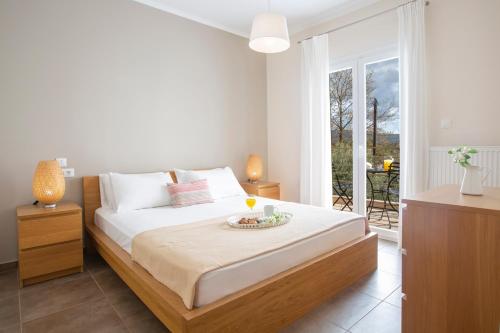 a bedroom with a bed with a bowl on it at Alegria Boutique Villas in Lygia