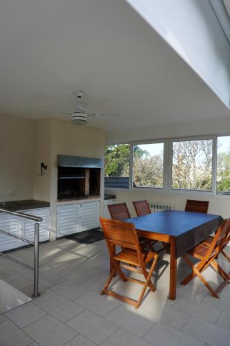 a dining room with a table and chairs at Aqualina Suites in Valeria del Mar