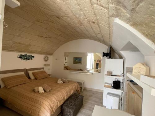a bedroom with a large bed in a room at Romantico Monolocale nel cuore di Otranto con garage in Otranto