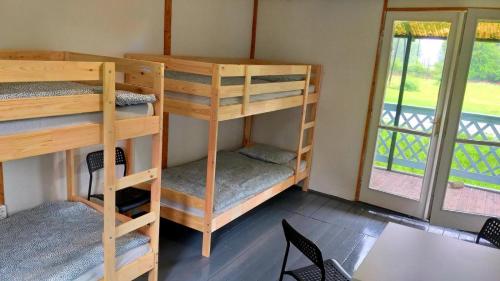 a room with two bunk beds and a window at Rakamaz Tisza Kemping in Rakamaz