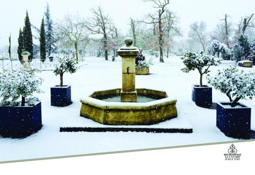 a fountain in a park covered in snow at Best Western Plus Le Canard sur le Toit in Colomiers