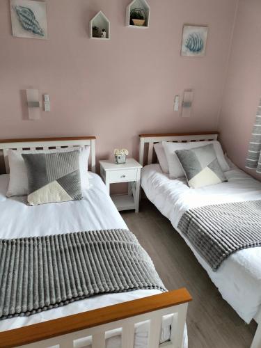 two beds sitting next to each other in a bedroom at Bay View Villas in Bucks Mills