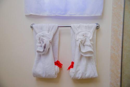 three towels hanging on a towel rack in a bathroom at Entire residential home • Trelawny• Smalls Villa in Florence Hall