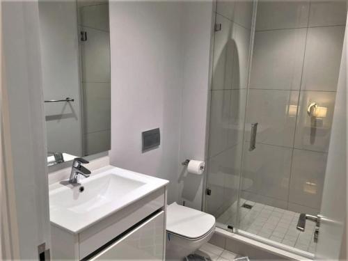 a bathroom with a sink and a toilet and a shower at Executive Suite at Ellipse in Waterfall Midrand in Midrand