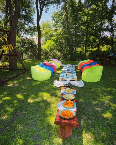 a long table with plates of food sitting on the grass at Frenki'S Residence in Velipojë