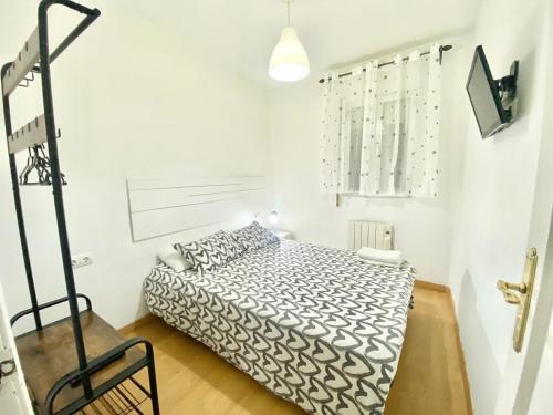 a bedroom with a bed in a white room at Jaime el Conquistador Apartment in Madrid