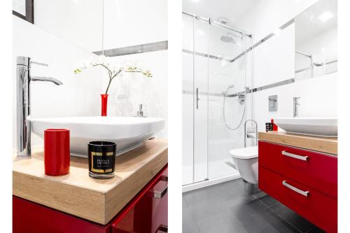 a bathroom with a red vanity and a white sink at HOUSEHOST Apartment:Lubicz 17D/5 in Krakow