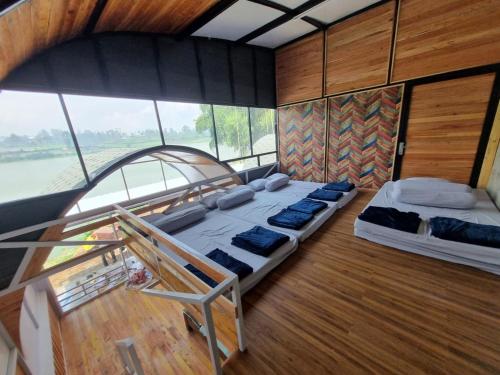 a room with two beds on a boat at Kampung Panorama in Pengalongan