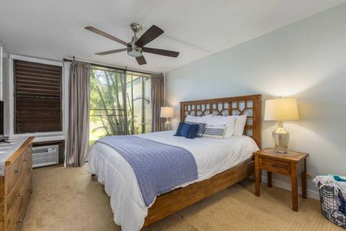 a bedroom with a bed and a ceiling fan at Gorgeous One Bedroom golf course front in Kahuku
