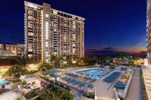 a large building with a swimming pool and a hotel at Ocean Front 1bd incredible view free wifi in Honolulu