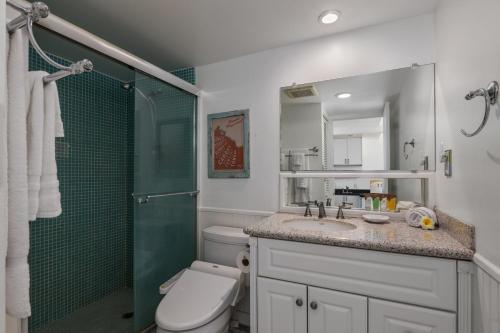 a bathroom with a shower and a toilet and a sink at Ocean Front Amazing One bedroom condo in Honolulu