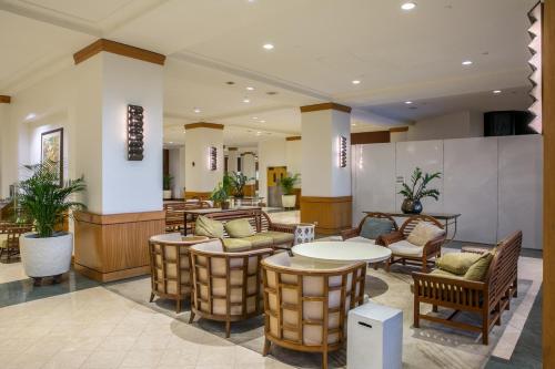 a lobby with tables and chairs in a building at Ocean Front 1bd incredible view free wifi in Honolulu