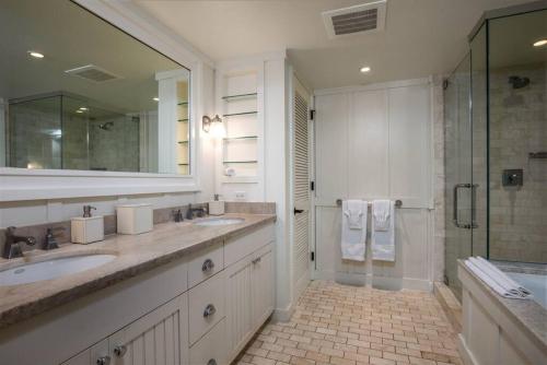 a large bathroom with two sinks and a shower at Glorious Beachfront high end Villa in Kahuku