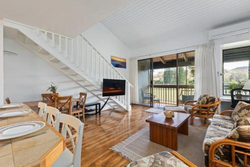 a living room with a couch and a table at Tropical Getaway perfect for families in Kahuku