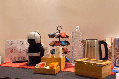 een tafel met een koffiezetapparaat en een fles water bij B&B o' Panar al Duomo in Napels
