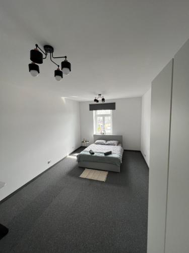 a white bedroom with a bed and a window at Cozy room between Kazimierz and the city center in Krakow