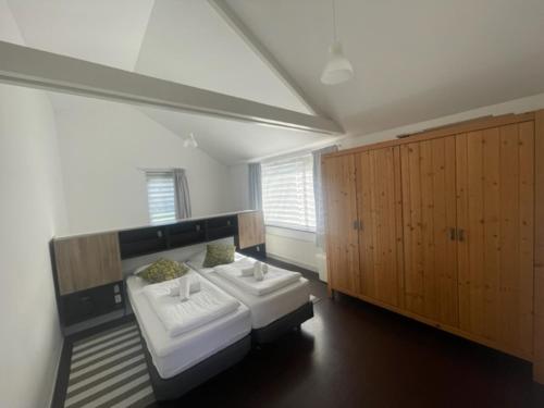 Habitación grande con 2 camas y armarios de madera. en HolidayHome Zonnestraal 9p Amsterdam and the beach, en Heerhugowaard