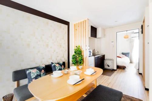 a living room with a wooden table and a dining room at Osaka Family Villa with Free Parking near Namba in Osaka