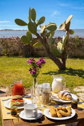 a table with plates of food and flowers on it at Laguna dei Fenici in Birgi Vecchi