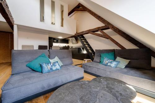 un soggiorno con due divani in mansarda di Le SeptQatre - Grand triplex au cœur de la Vieille Ville ad Annecy
