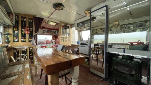 an old train room with a table and a kitchen at 2 x Double Bed Glamping Wagon at Dalby Forest in Scarborough
