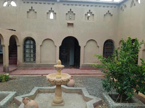 a fountain in the courtyard of a building at Dar Es Salam in Skoura