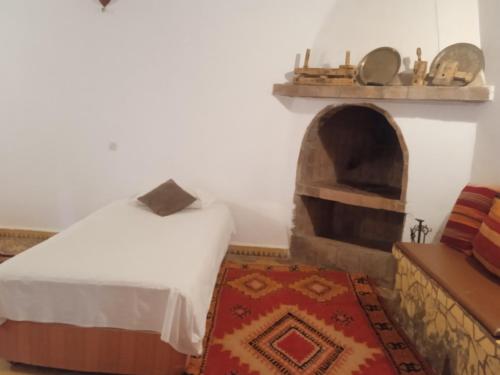 a bedroom with a bed and an oven at Dar Es Salam in Skoura