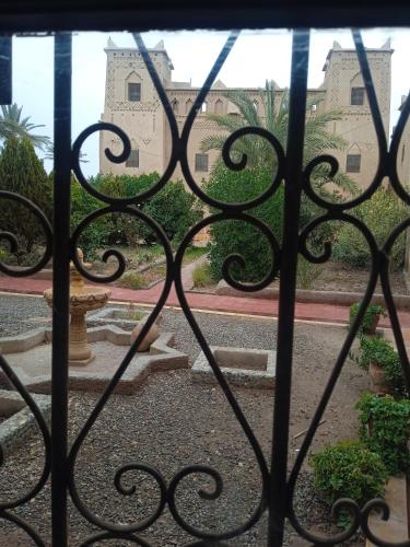 an iron gate with a view of a building at Dar Es Salam in Skoura