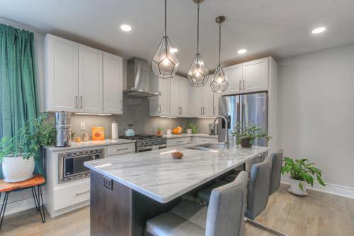 a kitchen with white cabinets and a large island at Luxury 3 Level East-Nash Home w/ Rooftop Terrace in Nashville