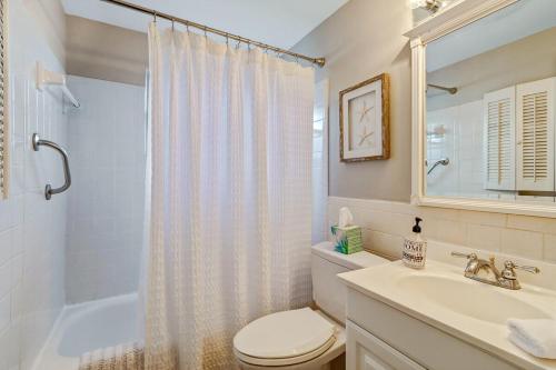 a bathroom with a toilet and a sink and a shower at Little Beach House w/ POOL&SPA - 5 minutes to Vanderbilt Beach (Pet Friendly) in Naples