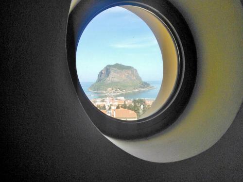 a round window with a view of a mountain at Villa Cazala in Monemvasia