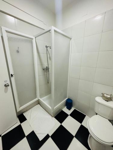 a bathroom with a shower and a toilet at MAKTVB Europa - Hostal Boutique in Santiago