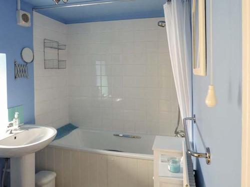 a bathroom with a tub and a sink and a bath tub at Gulls Hatch in Maryport