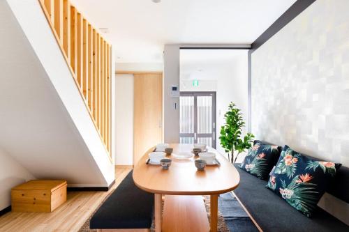 a living room with a table and a couch at Osaka Family Villa with Free Parking near Namba in Osaka
