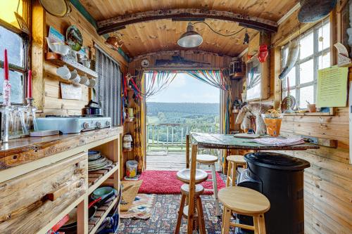 a kitchen with a table and chairs in a tiny house at Glamping Wagon - 1 x Double Bed 2 x Single Bed in Scarborough