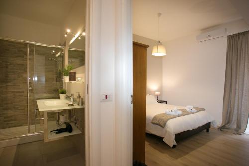 um quarto com uma cama e uma casa de banho com um lavatório em Thebestinrome Piazza del Popolo - Vico em Roma